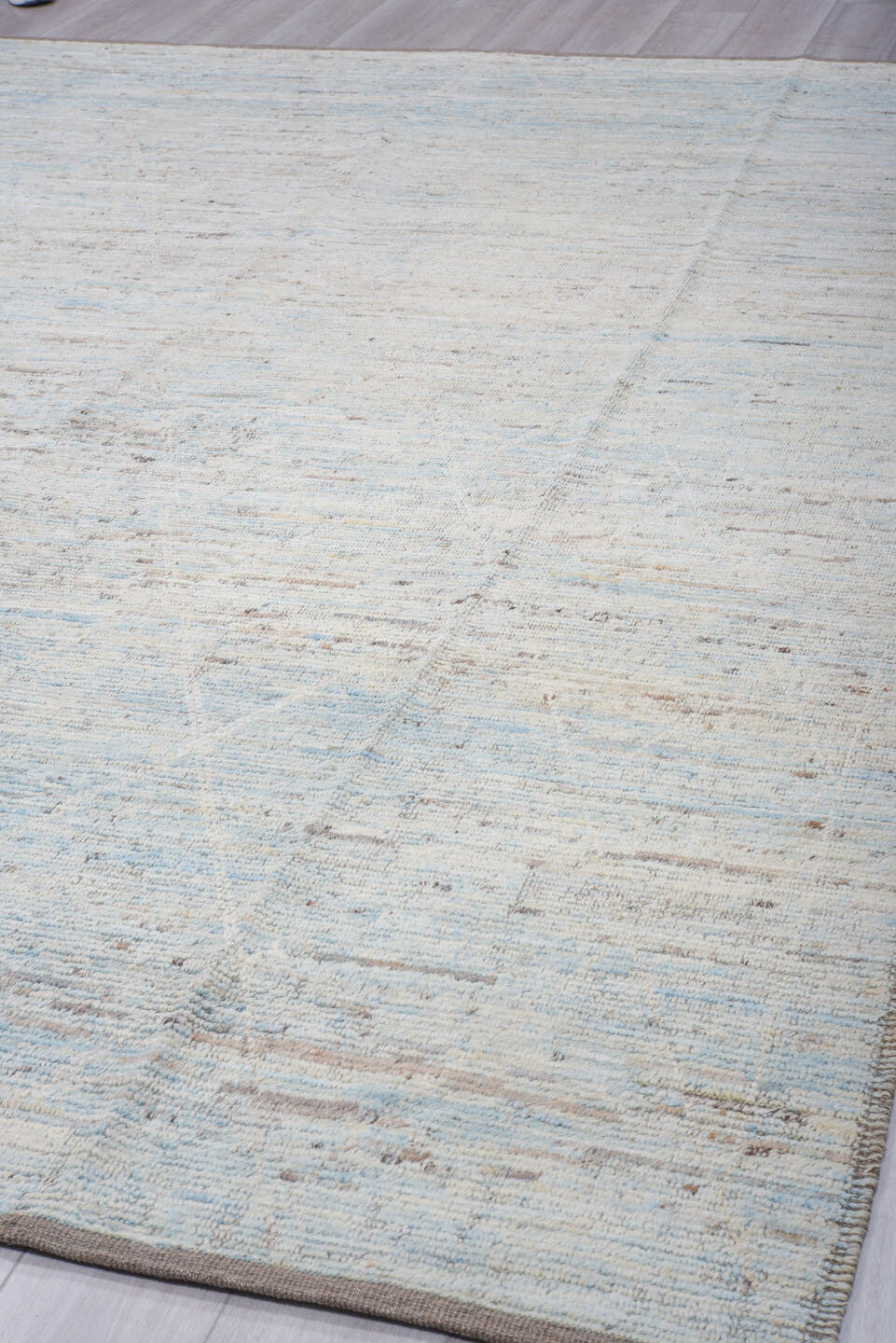 9' x 12' one-of-a-kind handmade vintage Tulu large size rug. Color palette: ivory, pale blue, sky blue, taupe, gray