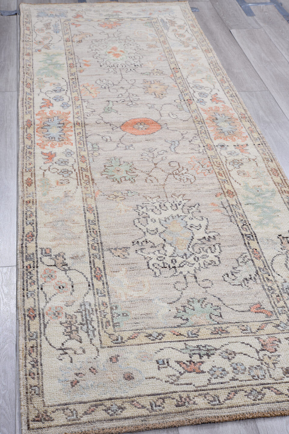 3' x 9' one-of-a-kind handmade vintage Oushak runner rug. Color palette: ivory, taupe, slate, sage, coral, muted blue, cream