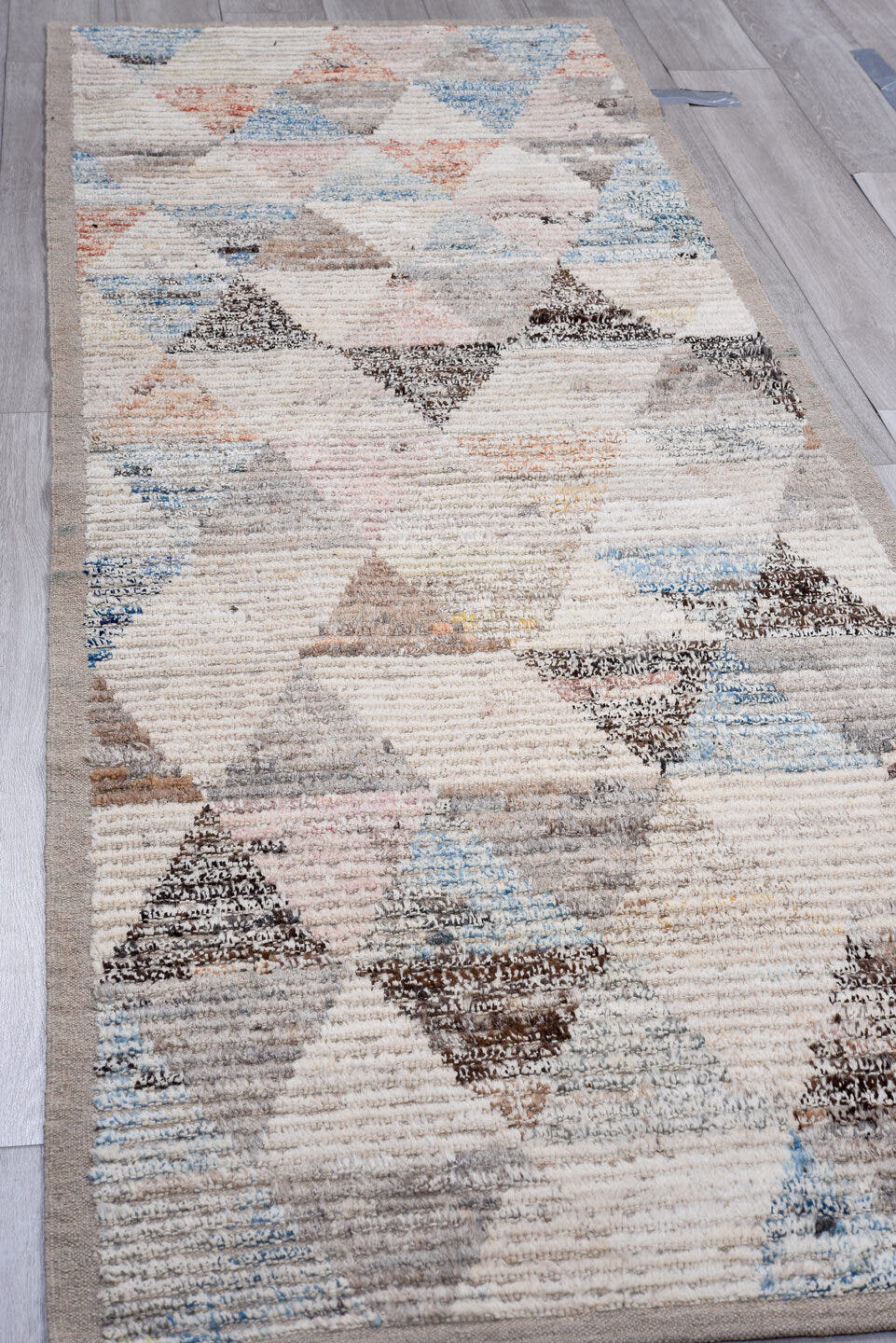 3' x 9' one-of-a-kind handmade vintage Tulu runner rug. Color palette: ivory, taupe, gray, charcoal, sky blue, blush, rust