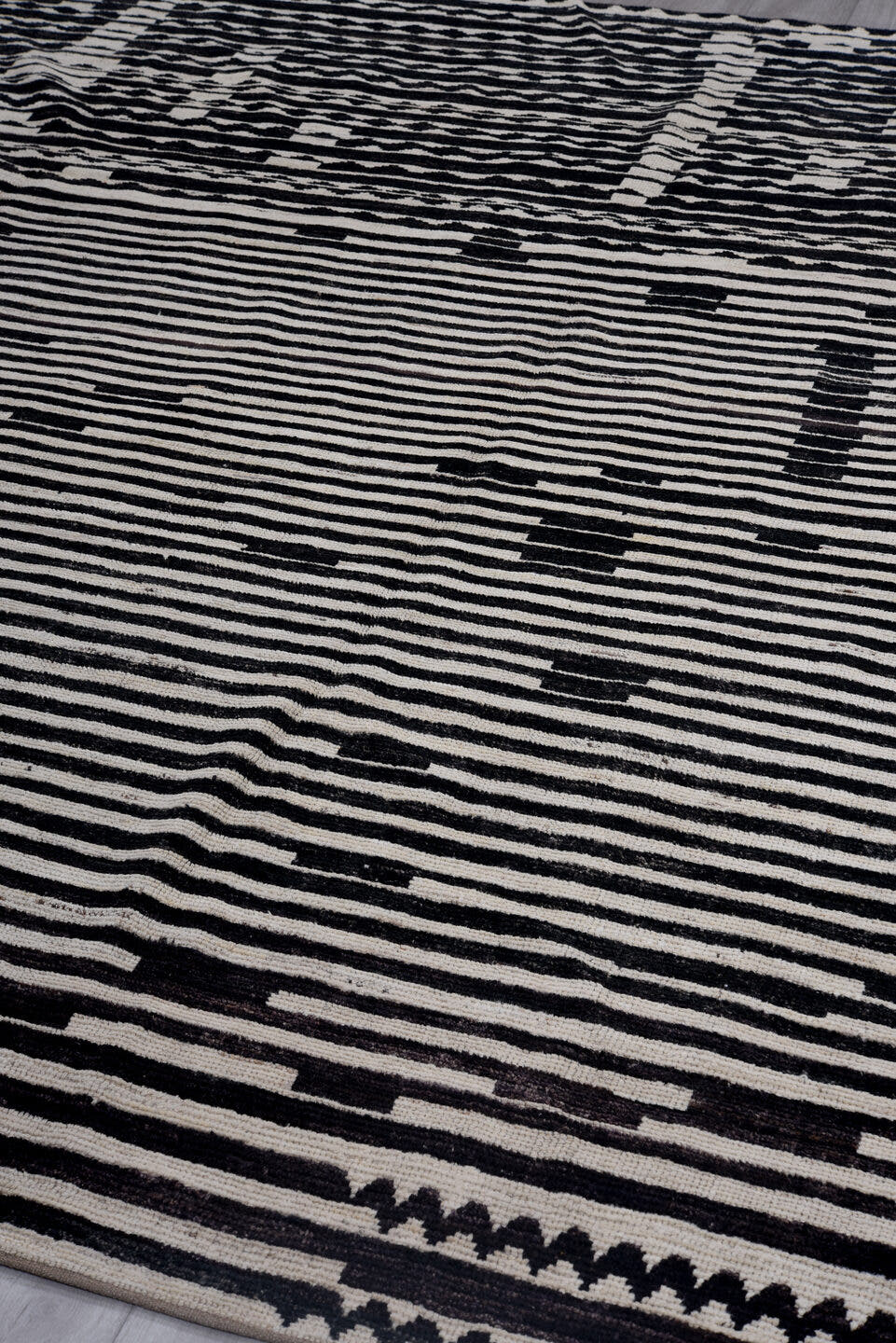 8' x 9' one-of-a-kind handmade vintage Tulu rug. Color palette: ivory, black, charcoal, gray