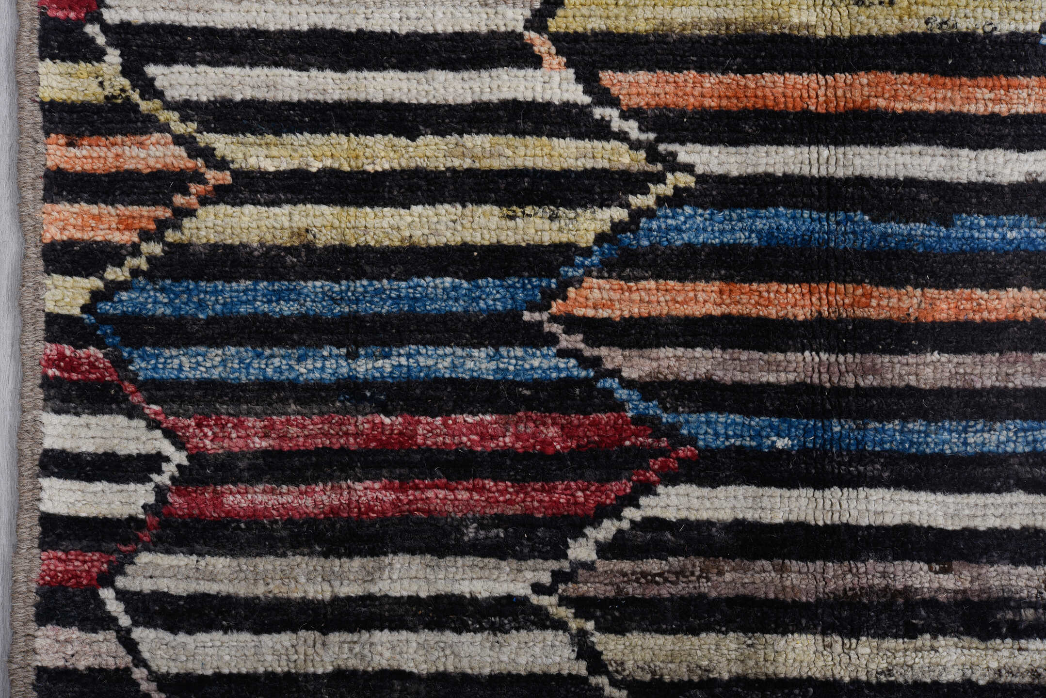 9' x 11' one-of-a-kind handmade vintage Tulu large size rug. Color palette: ivory, charcoal, indigo, crimson, rust, slate