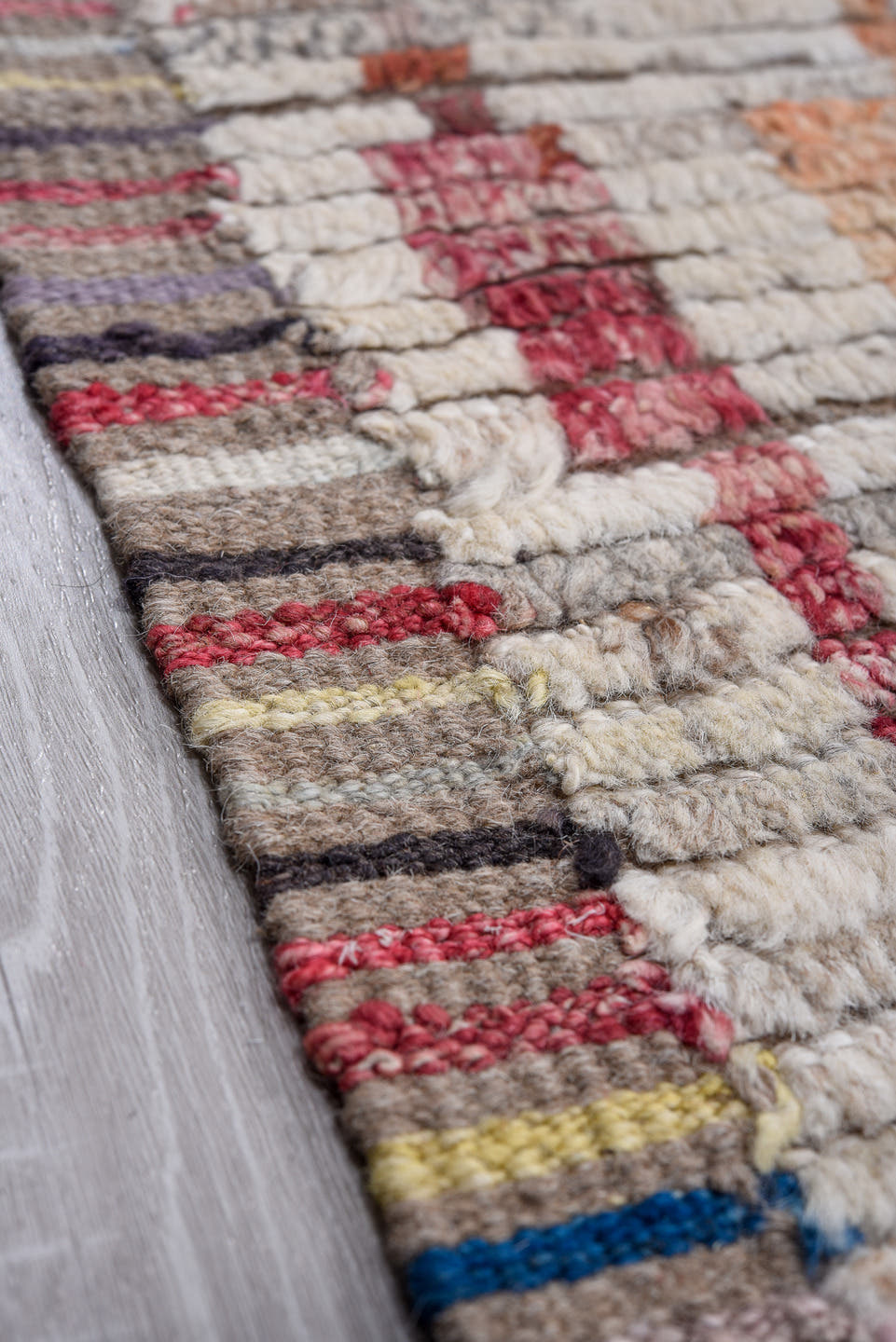 13' x 16' one-of-a-kind handmade vintage Tulu oversize rug. Color palette: ivory, gray, pink, charcoal, sky blue, gold