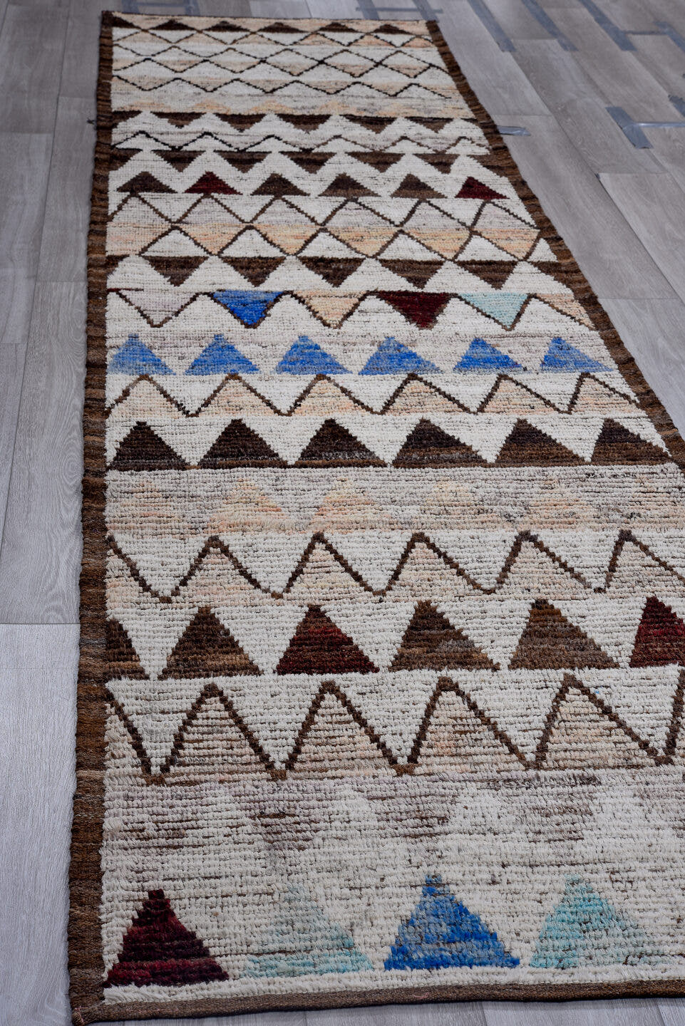3' x 13' one-of-a-kind handmade vintage Tulu runner rug. Color palette: ivory, brown, blue, blush, burgundy, taupe, pink