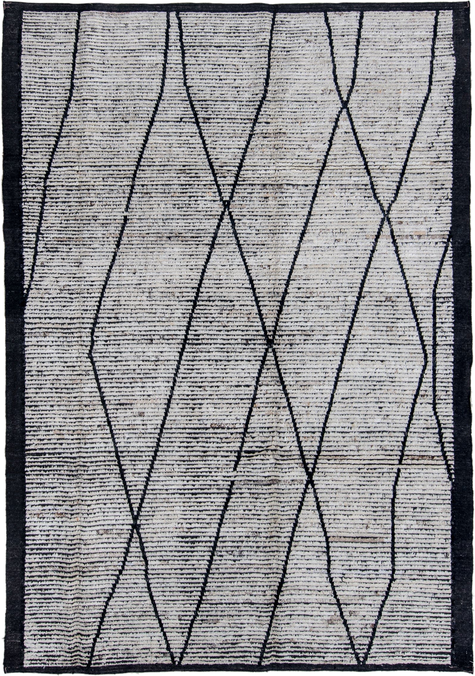 6' x 9' one-of-a-kind handmade vintage Tulu rug. Color palette: ivory, charcoal, black, gray