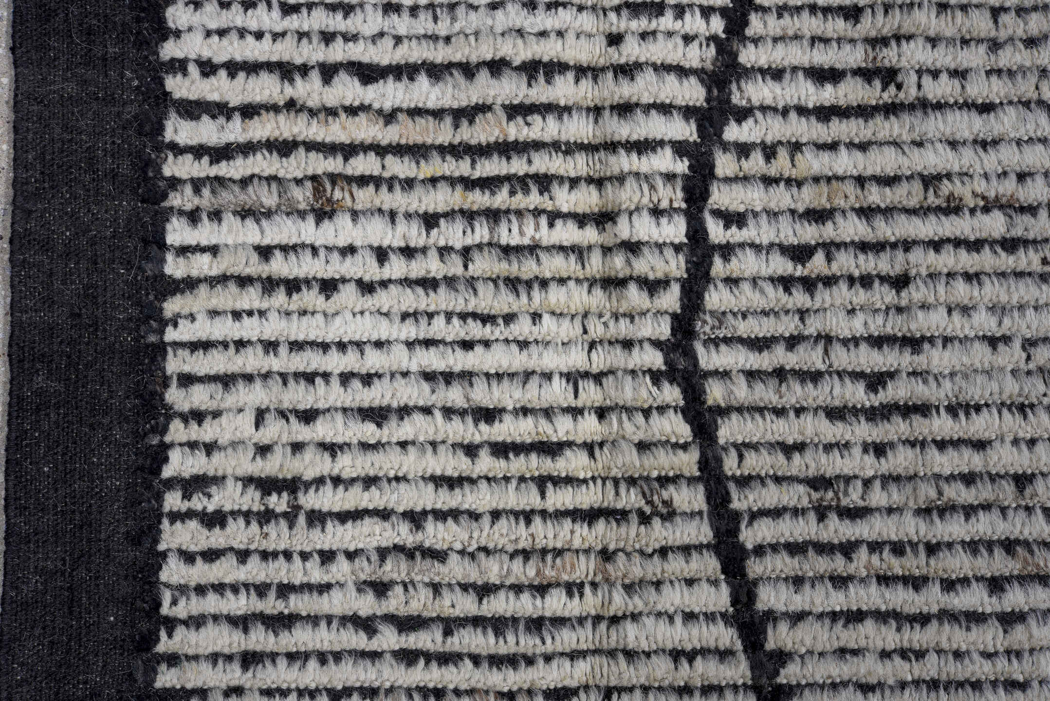 6' x 9' one-of-a-kind handmade vintage Tulu rug. Color palette: ivory, charcoal, black, gray