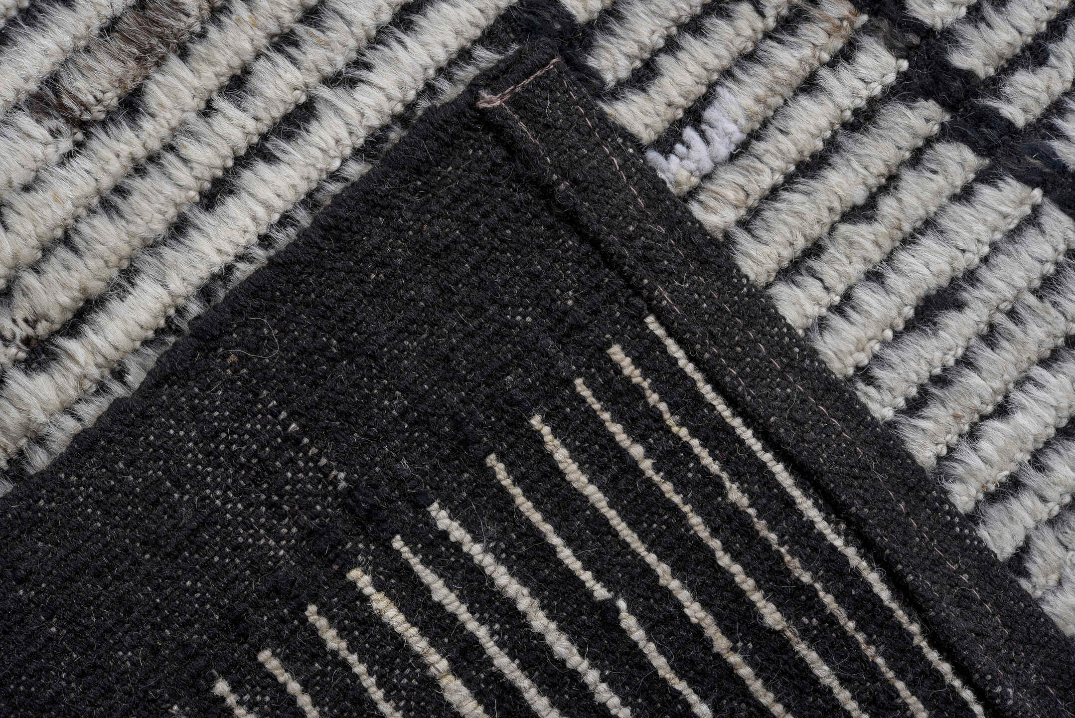 6' x 9' one-of-a-kind handmade vintage Tulu rug. Color palette: ivory, charcoal, black, gray