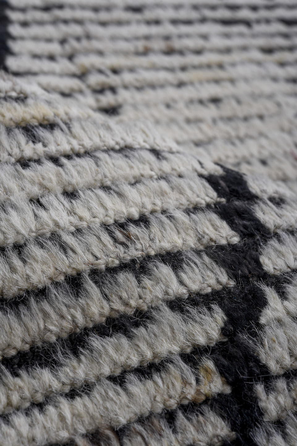 6' x 9' one-of-a-kind handmade vintage Tulu rug. Color palette: ivory, charcoal, black, gray