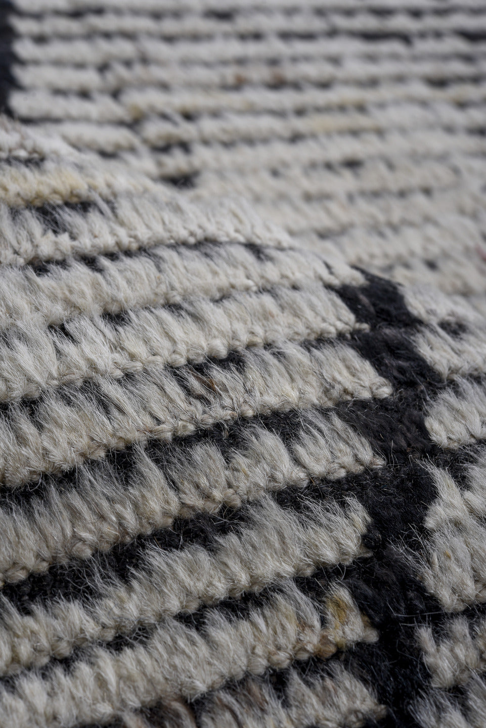 6' x 9' one-of-a-kind handmade vintage Tulu rug. Color palette: ivory, charcoal, black, gray