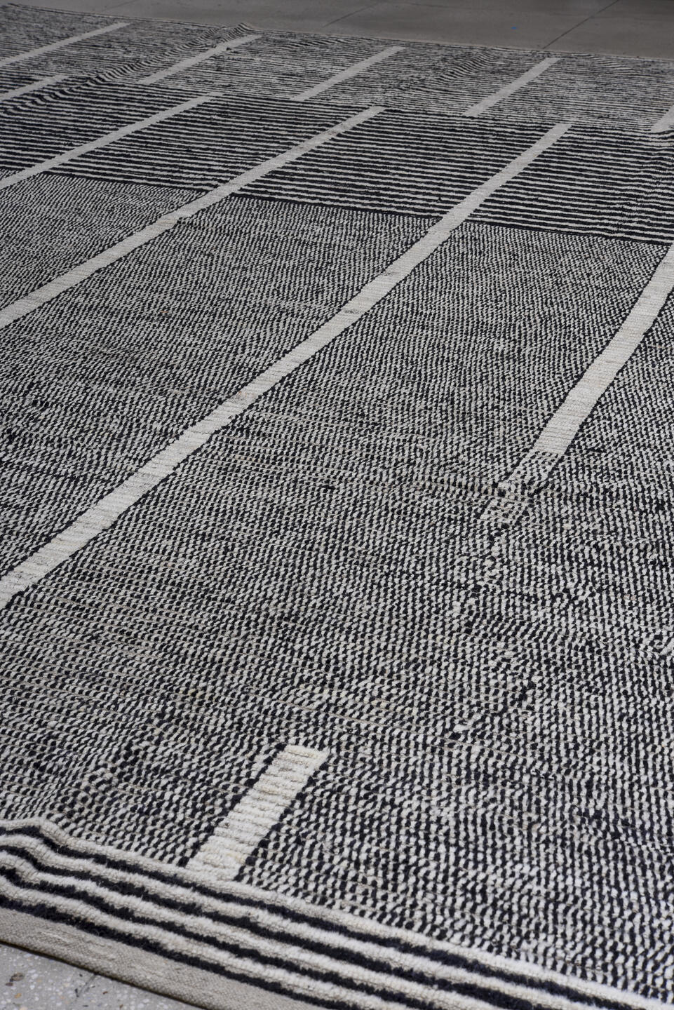 13' x 16' one-of-a-kind handmade vintage Tulu oversize rug. Color palette: ivory, charcoal, gray, black