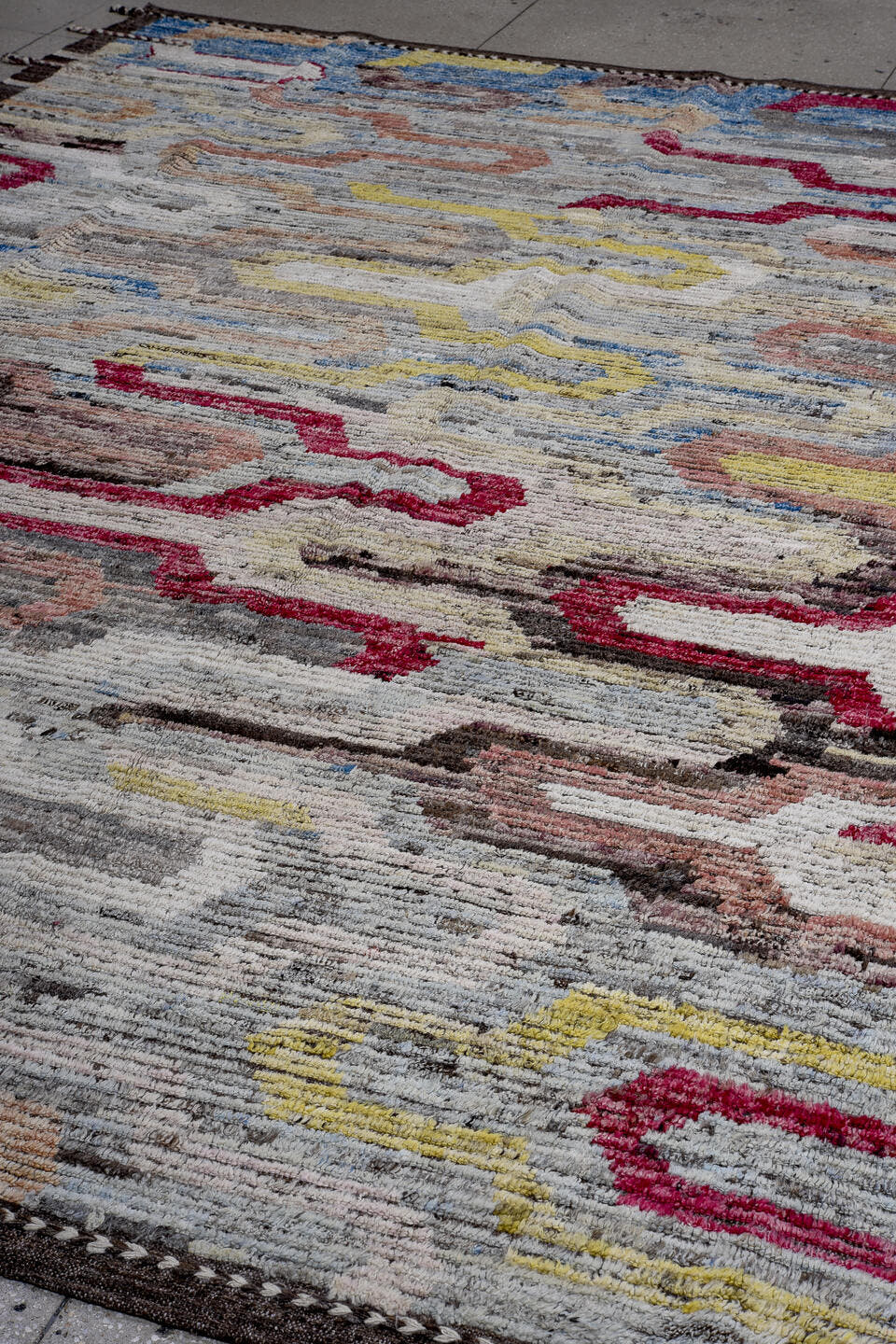 9' x 12' one-of-a-kind handmade vintage Tulu large size rug. Color palette: ivory, gray, charcoal, raspberry, sky blue