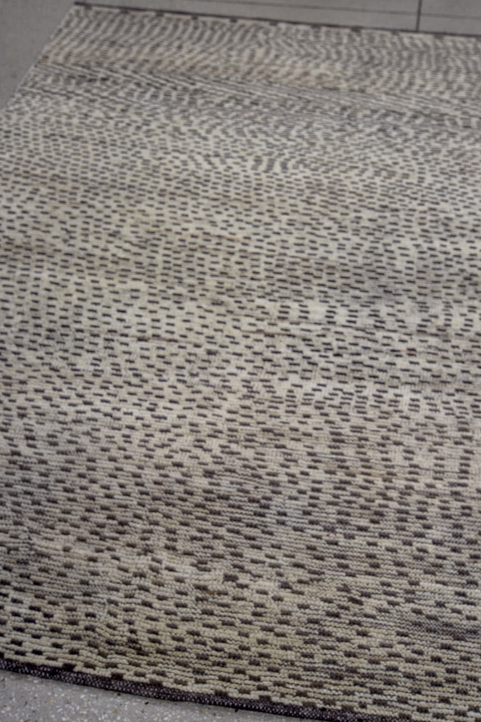 4' x 7' one-of-a-kind handmade vintage Tulu rug. Color palette: ivory, charcoal, gray, black