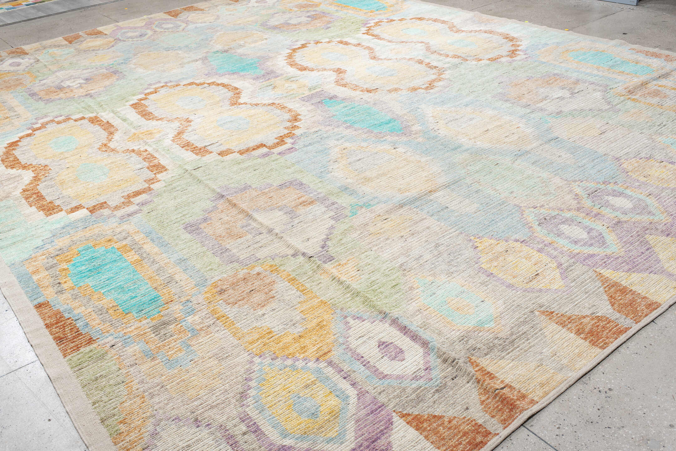 13' x 17' one-of-a-kind handmade vintage Tulu oversize rug. Color palette: ivory, aqua, lavender, pale_gold, coral, sage
