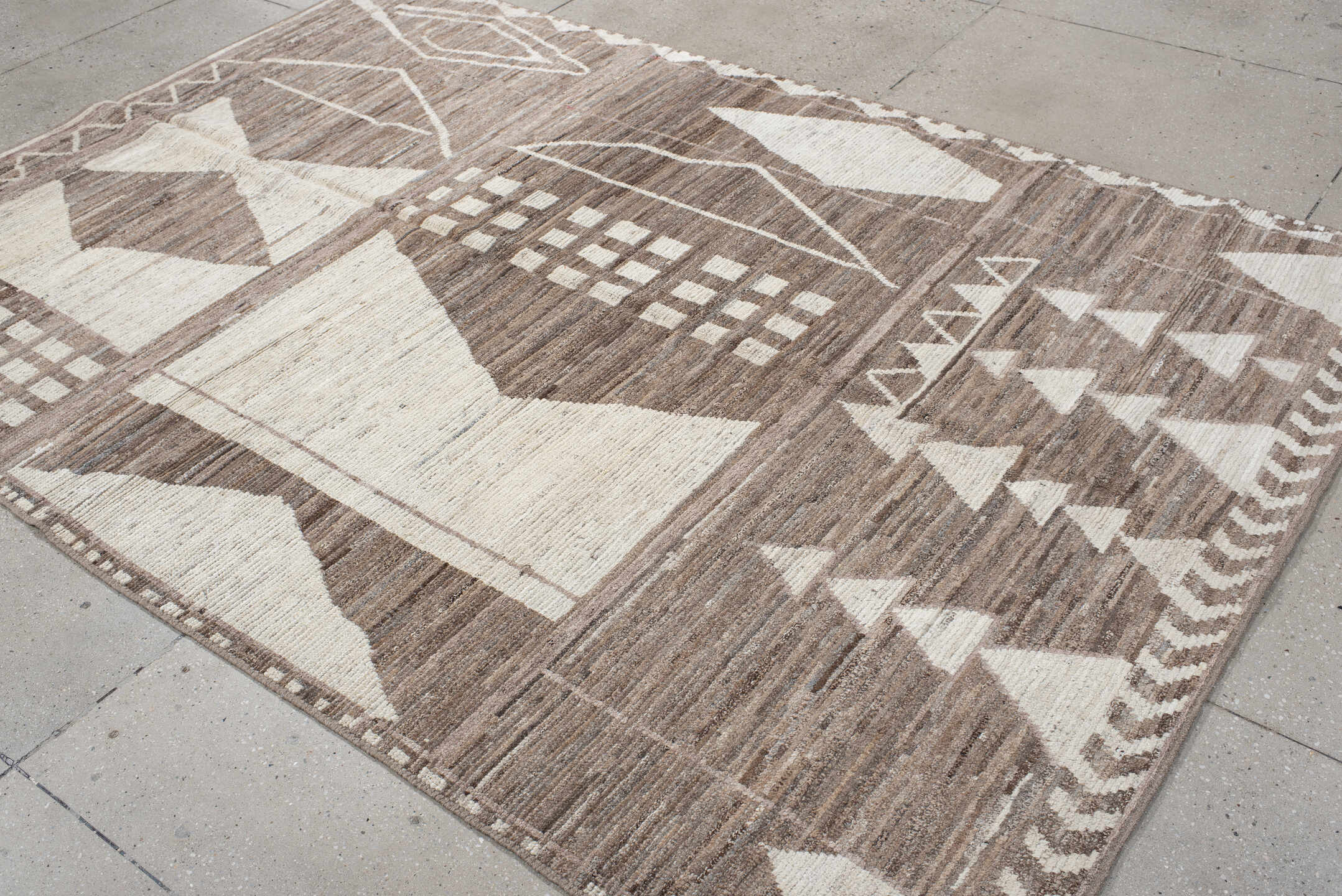 7' x 9' one-of-a-kind handmade vintage Tulu rug. Color palette: ivory, taupe, brown, charcoal, cream, rose, slate, pale blue