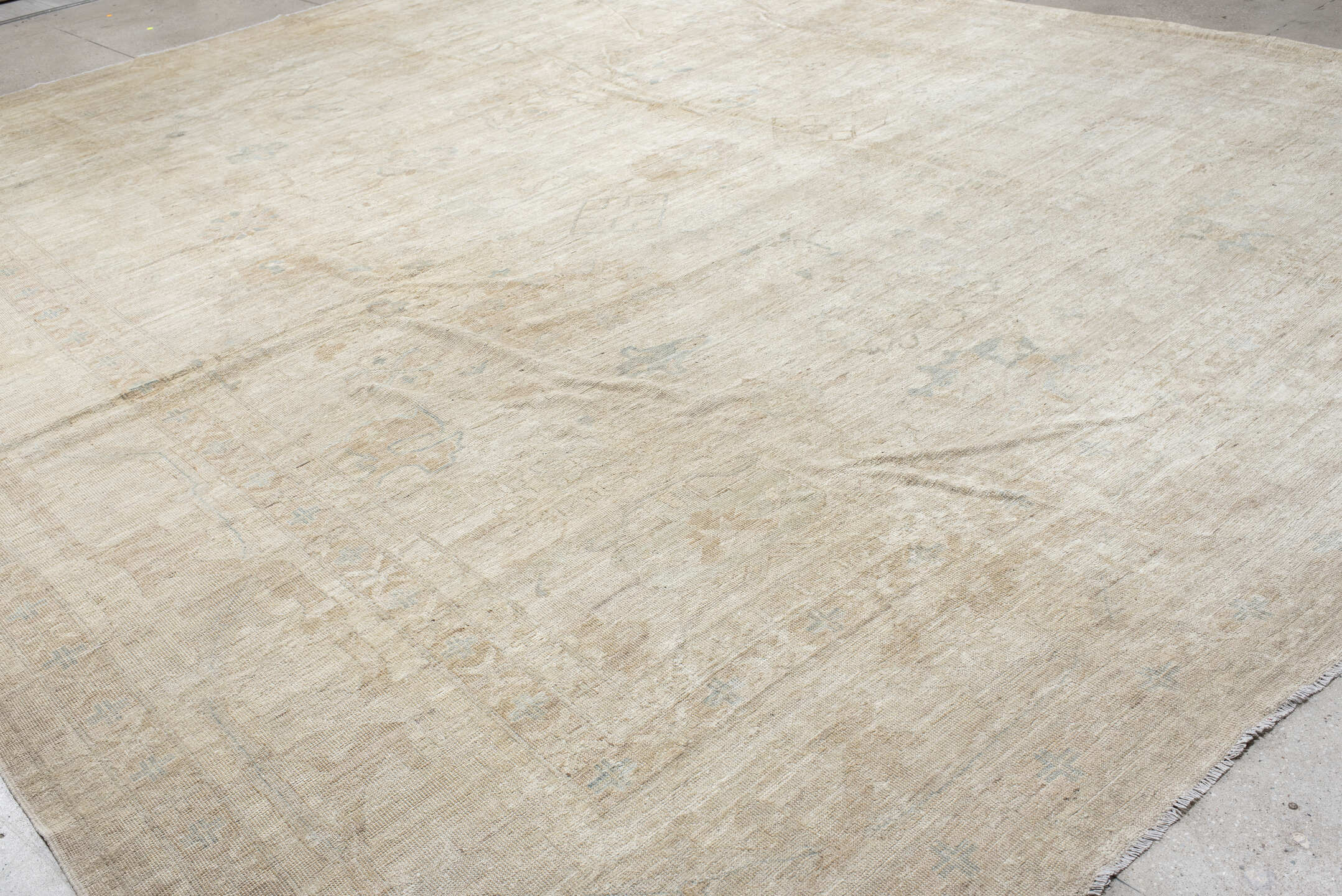 14' x 17' one-of-a-kind handmade vintage Tulu oversize rug. Color palette: ivory, beige, taupe, pale blue, cream, sand, gray