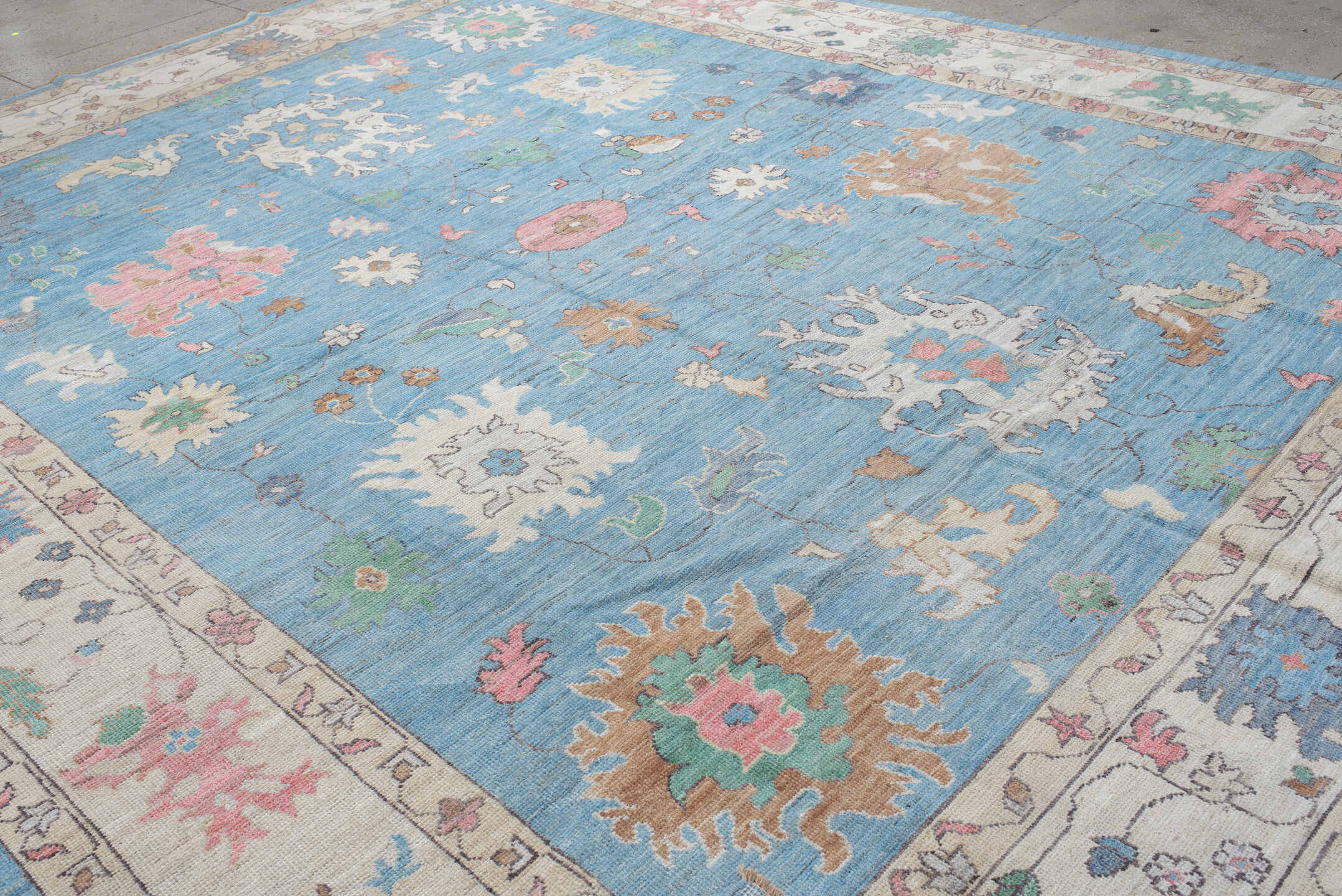 12' x 15' one-of-a-kind handmade vintage Oushak oversize rug. Color palette: sky blue, ivory, blush, sage, muted gold, taupe