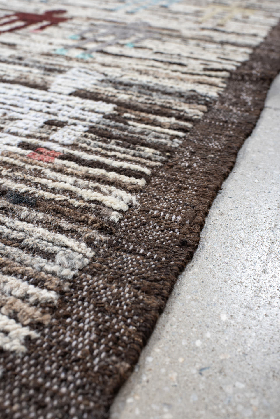 8' x 9' one-of-a-kind handmade vintage Tulu rug. Color palette: ivory, brown, taupe, rust, pale_blue, charcoal, burgundy