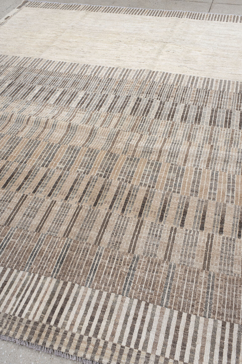 7' x 9' one-of-a-kind handmade vintage Tulu rug. Color palette: ivory, taupe, camel, charcoal, beige, gray, black