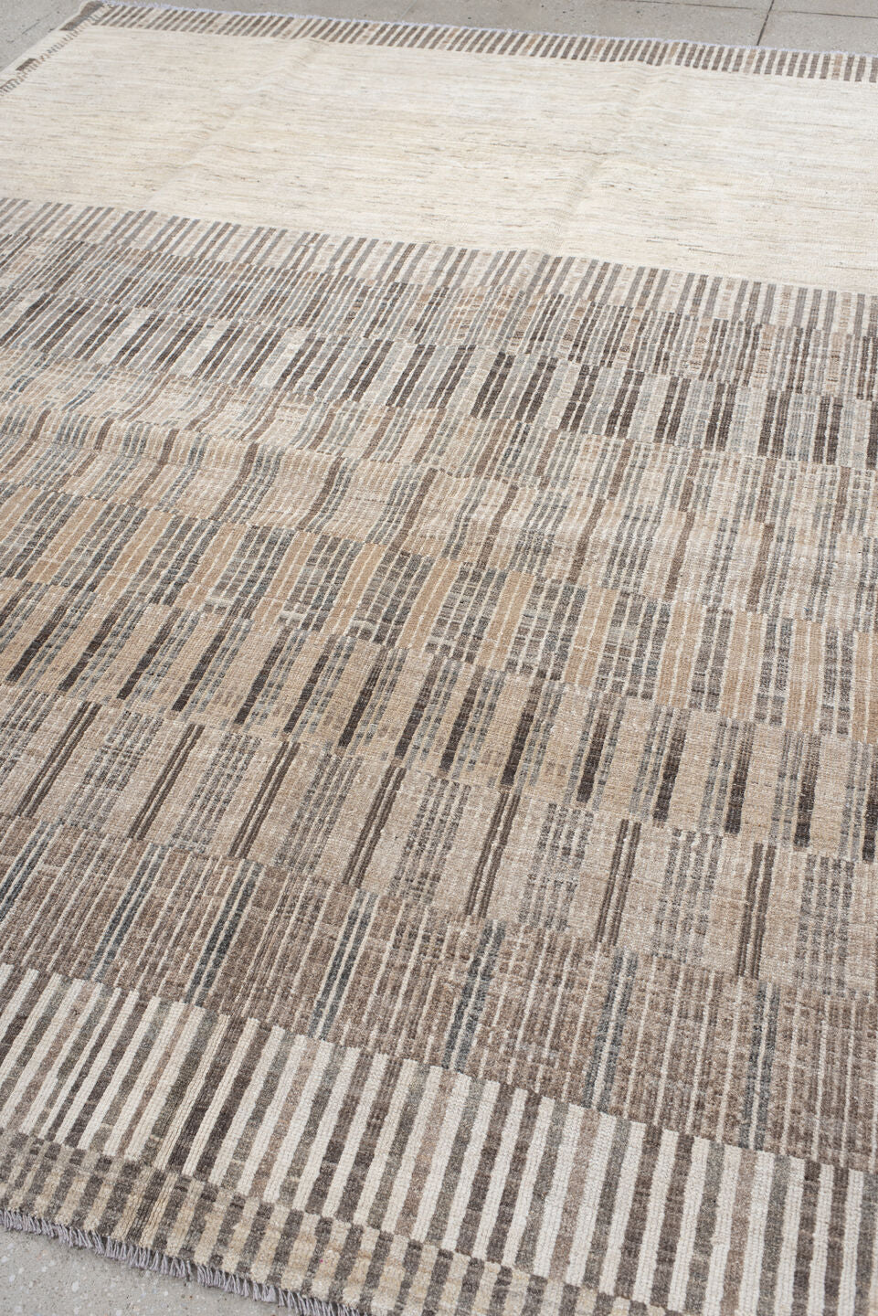 7' x 9' one-of-a-kind handmade vintage Tulu rug. Color palette: ivory, taupe, camel, charcoal, beige, gray, black