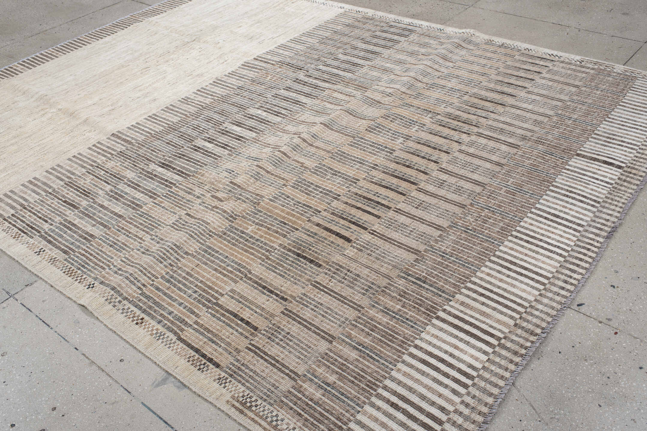 7' x 9' one-of-a-kind handmade vintage Tulu rug. Color palette: ivory, taupe, camel, charcoal, beige, gray, black