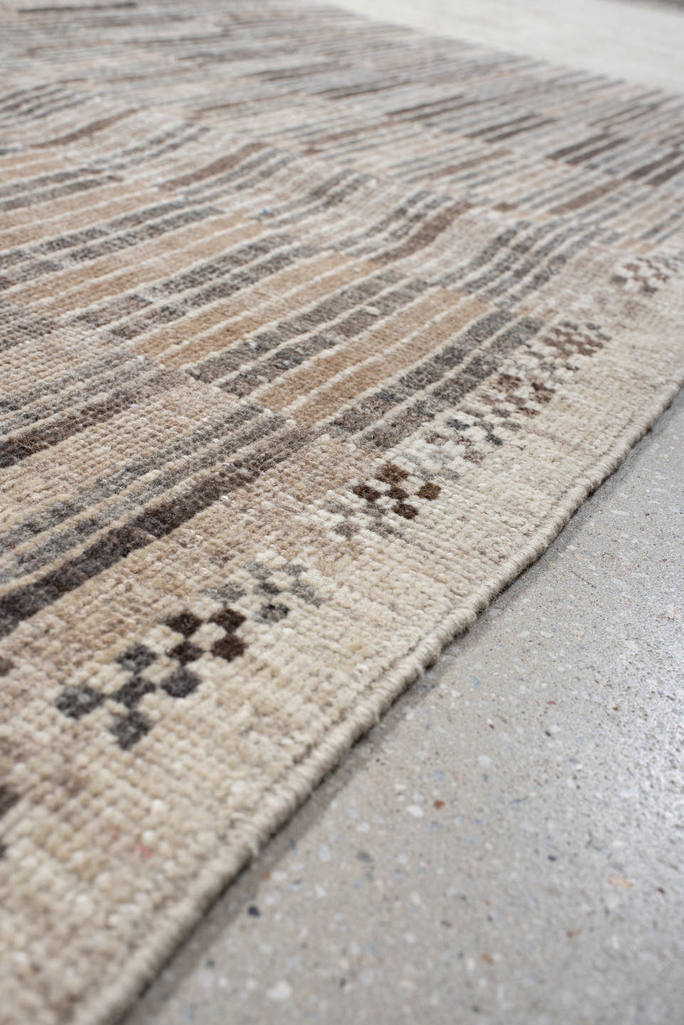 7' x 9' one-of-a-kind handmade vintage Tulu rug. Color palette: ivory, taupe, camel, charcoal, beige, gray, black