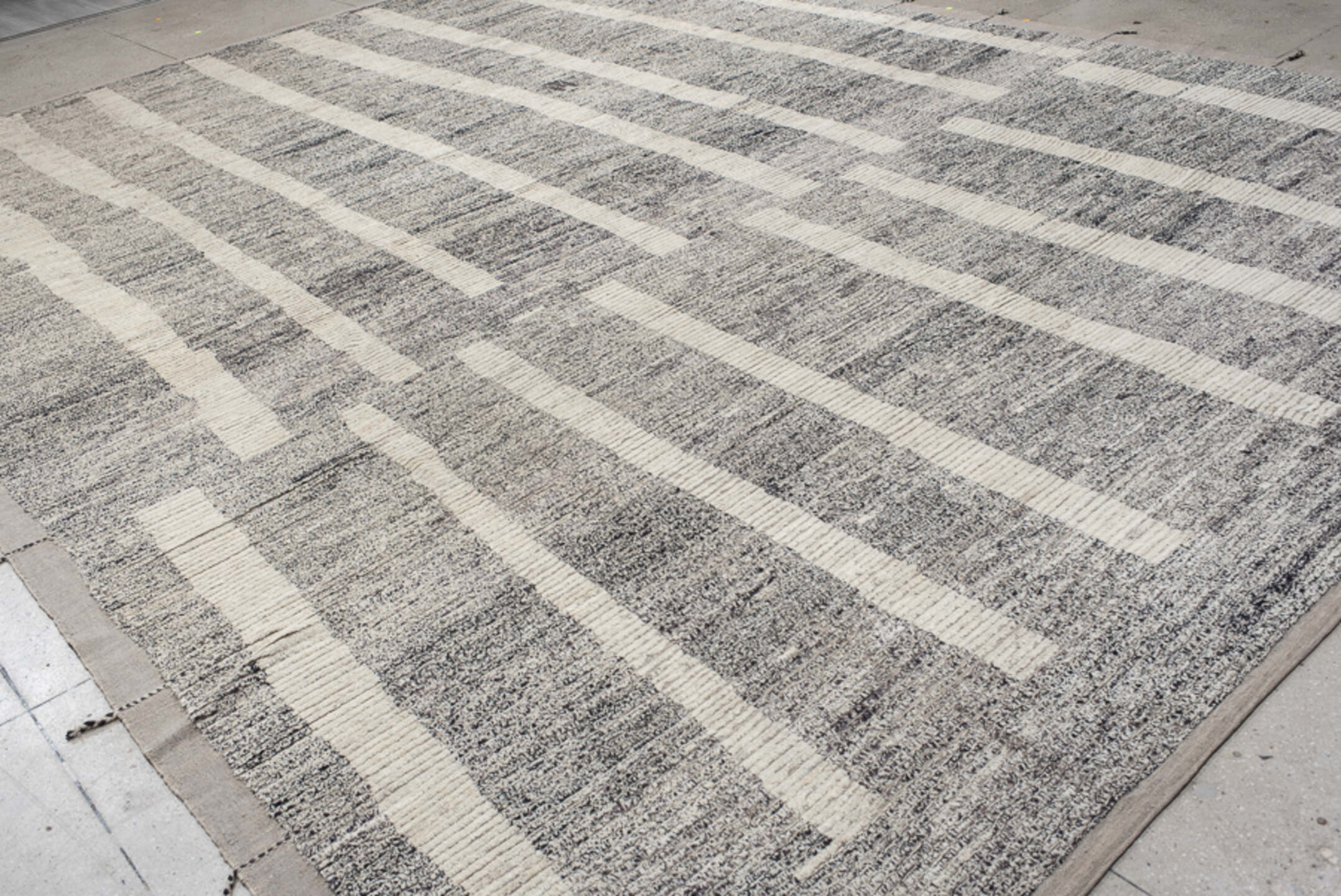 12' x 17' one-of-a-kind handmade vintage Tulu oversize rug. Color palette: gray, ivory, charcoal, taupe, black, beige