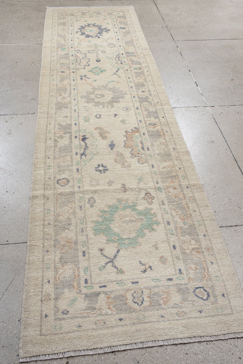 2' x 10' one-of-a-kind handmade vintage Oushak runner rug. Color palette: ivory, light gray, aqua, blue, beige, peach, teal