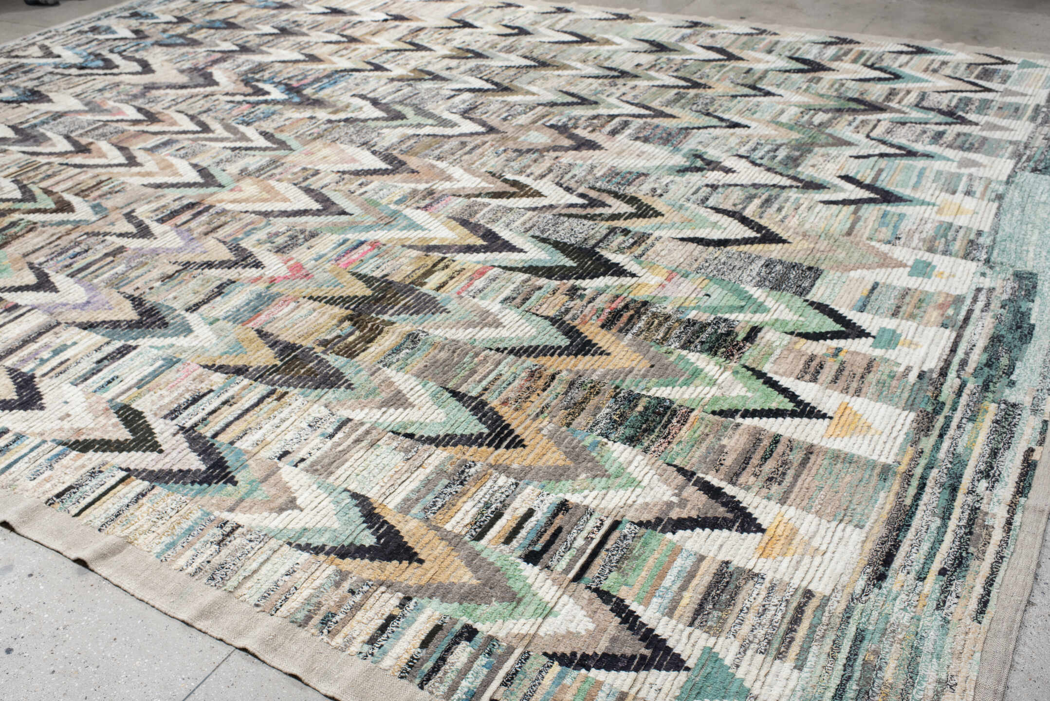 13' x 17' one-of-a-kind handmade vintage Tulu oversize rug. Color palette: ivory, gray, charcoal, aqua, taupe, sage, cream