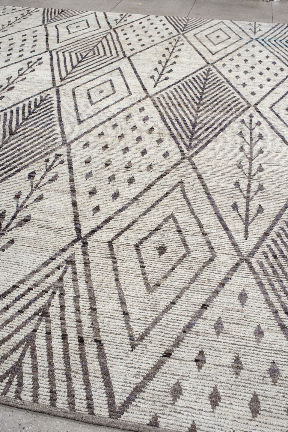12' x 15' one-of-a-kind handmade vintage Tulu oversize rug. Color palette: ivory, charcoal, taupe, brown, gray, black, beige