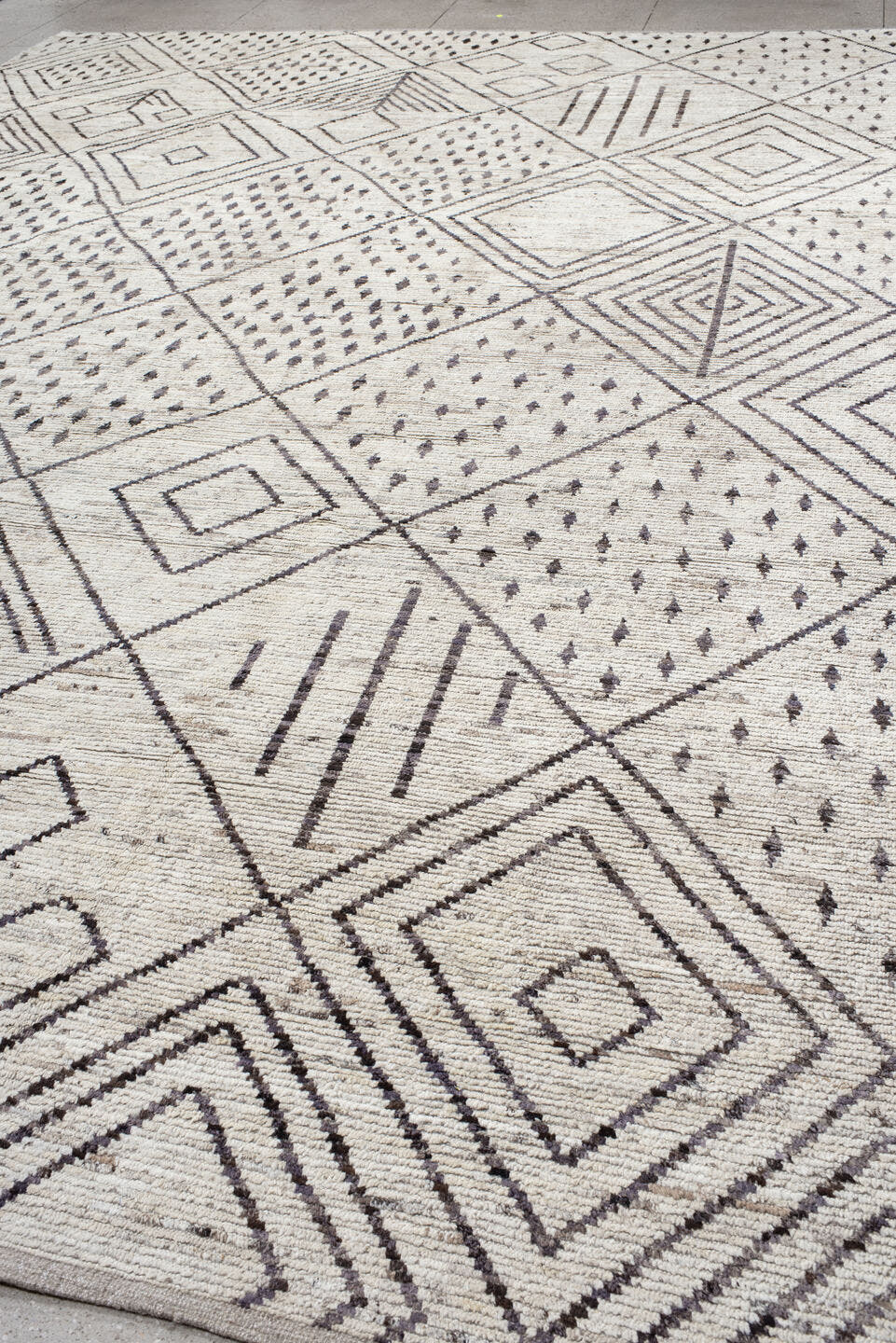 12' x 17' one-of-a-kind handmade vintage Tulu oversize rug. Color palette: ivory, charcoal, taupe, brown, gray, black, beige
