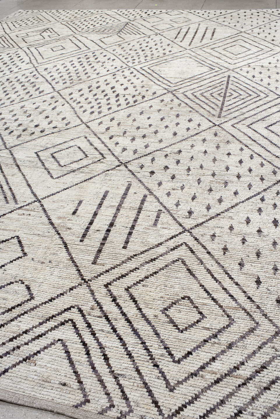12' x 17' one-of-a-kind handmade vintage Tulu oversize rug. Color palette: ivory, charcoal, taupe, brown, gray, black, beige