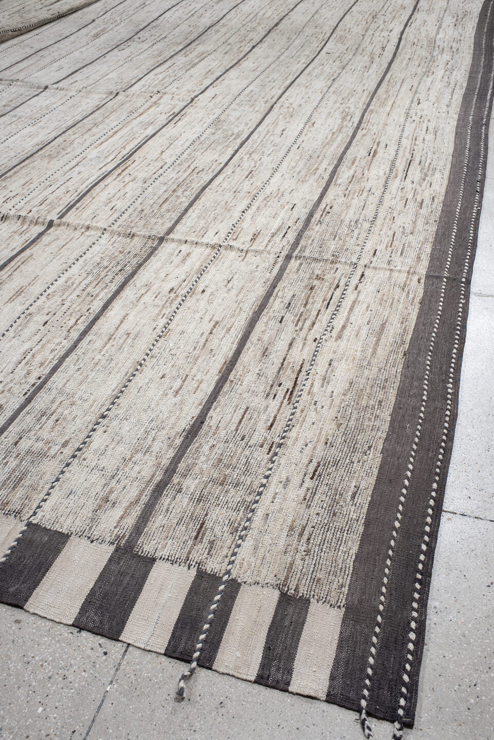 19' x 28' one-of-a-kind handmade vintage Tulu oversize rug. Color palette: ivory, charcoal, taupe, brown, gray, black, beige