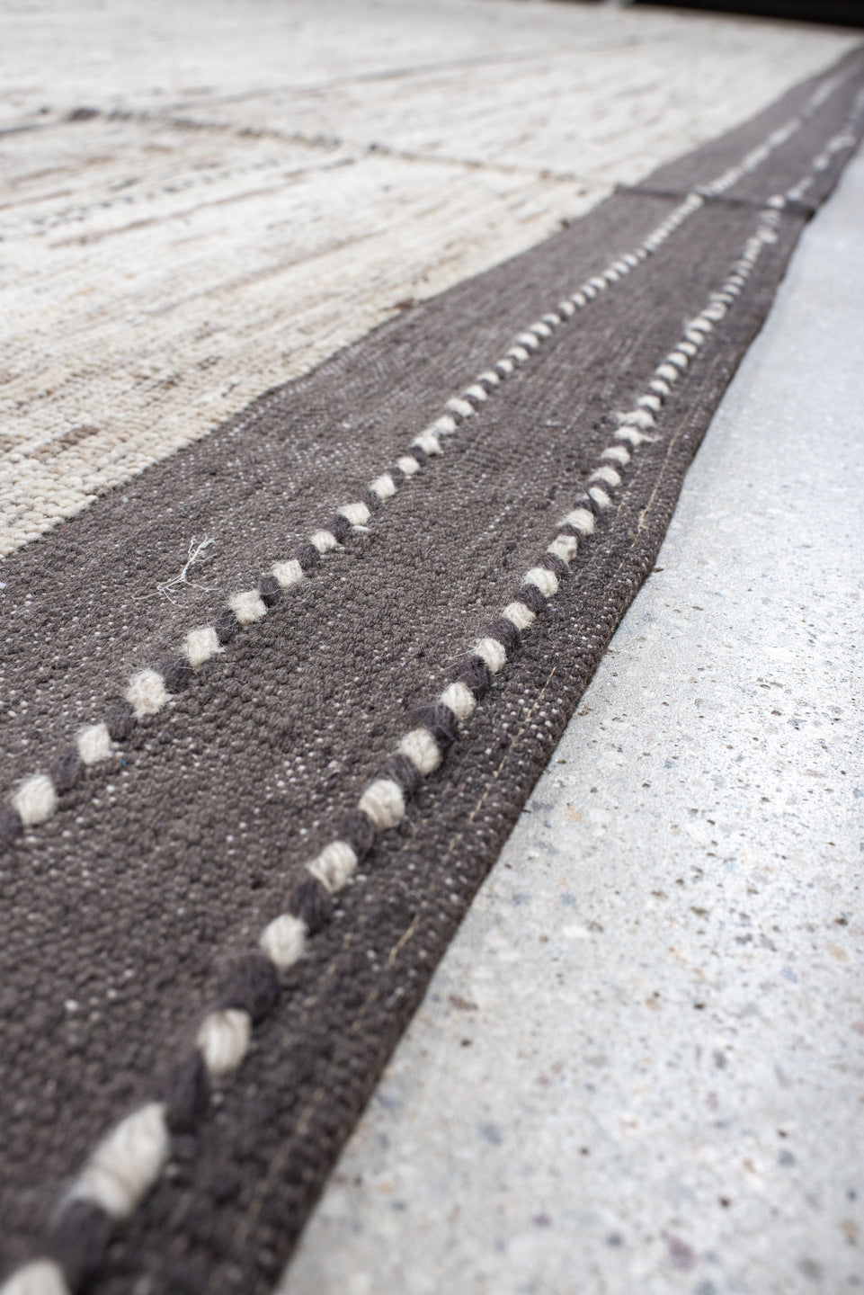 19' x 28' one-of-a-kind handmade vintage Tulu oversize rug. Color palette: ivory, charcoal, taupe, brown, gray, black, beige