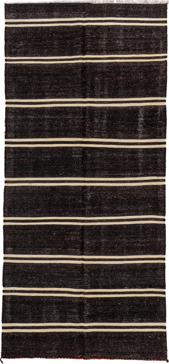 5' x 11' one-of-a-kind handmade vintage  rug. Color palette: black, brown, gray, off-white, orange, red
