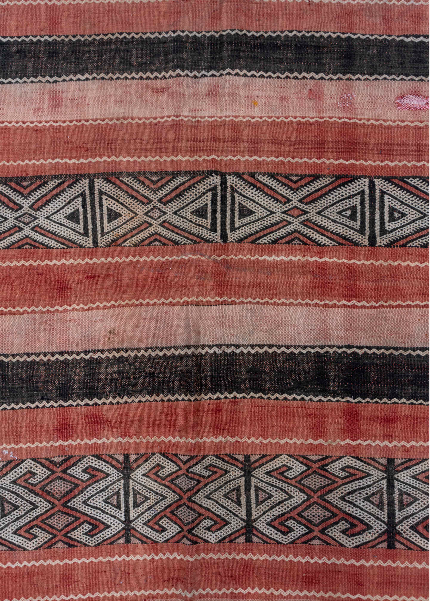 5' x 8' one-of-a-kind handmade vintage Jijim medium size rug. Color palette: black, brown, gray, light gray, orange, pink