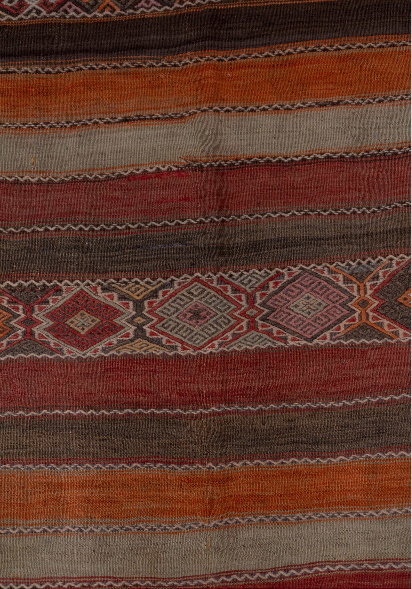4' x 10' one-of-a-kind handmade vintage Jijim runner rug. Color palette: brown, gray, pink, red, redwood