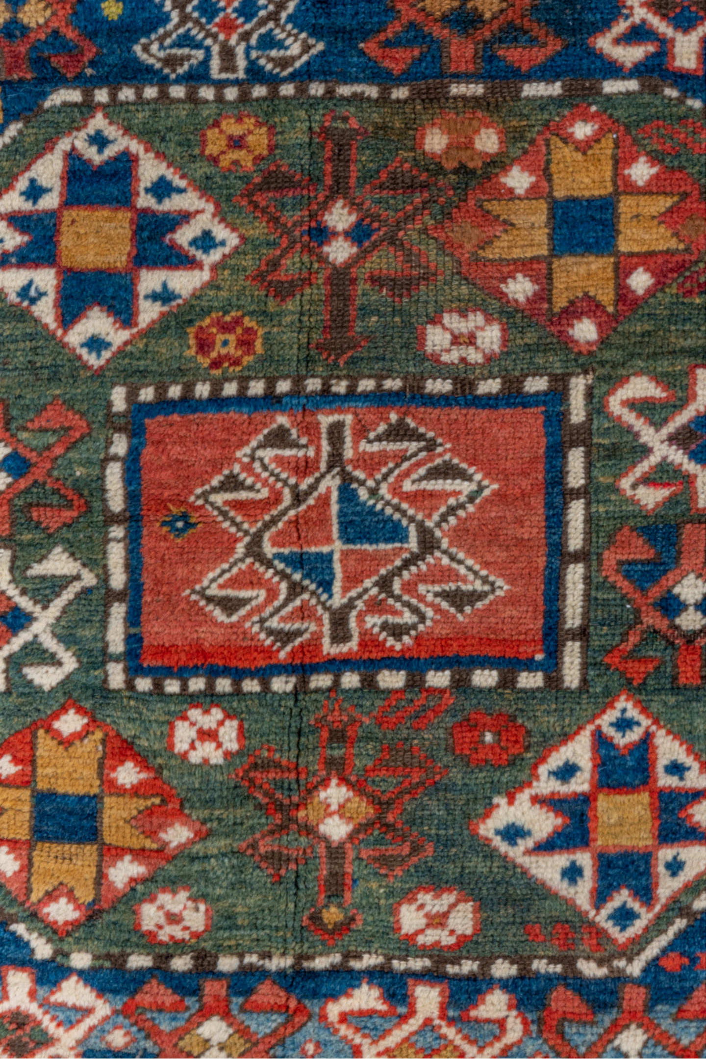 4' x 6' one-of-a-kind handmade vintage Kazak small size rug. Color palette: blue, brown, gray, pink, red