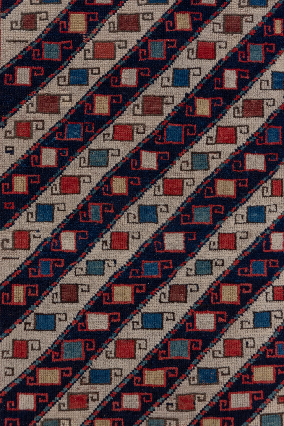 3' x 12' one-of-a-kind handmade vintage Genje runner rug. Color palette: black, blue, brown, gray, pink, red