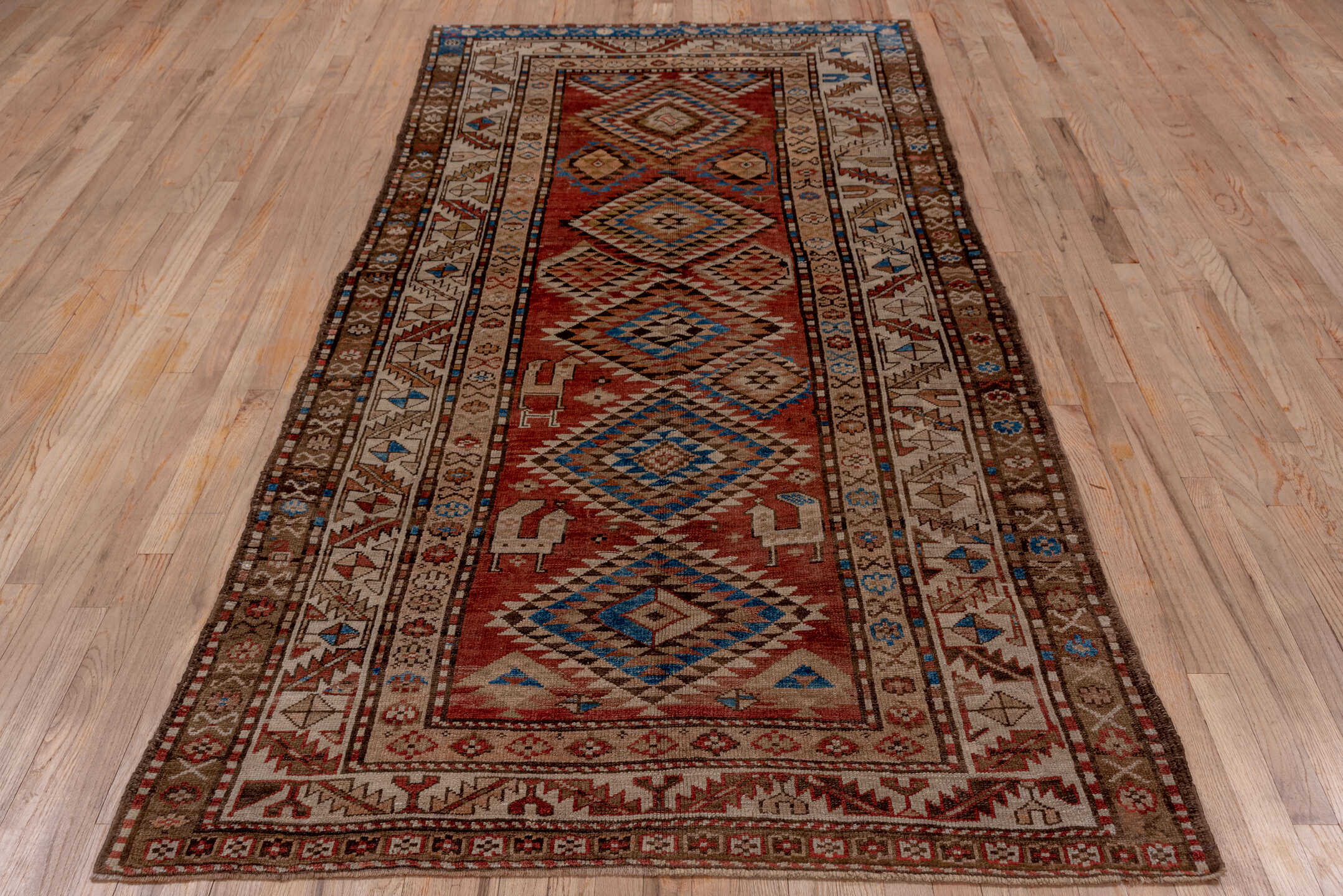 4' x 9' one-of-a-kind handmade vintage Kurd runner rug. Color palette: brown, gray, blue, pink, light gray, arapawa