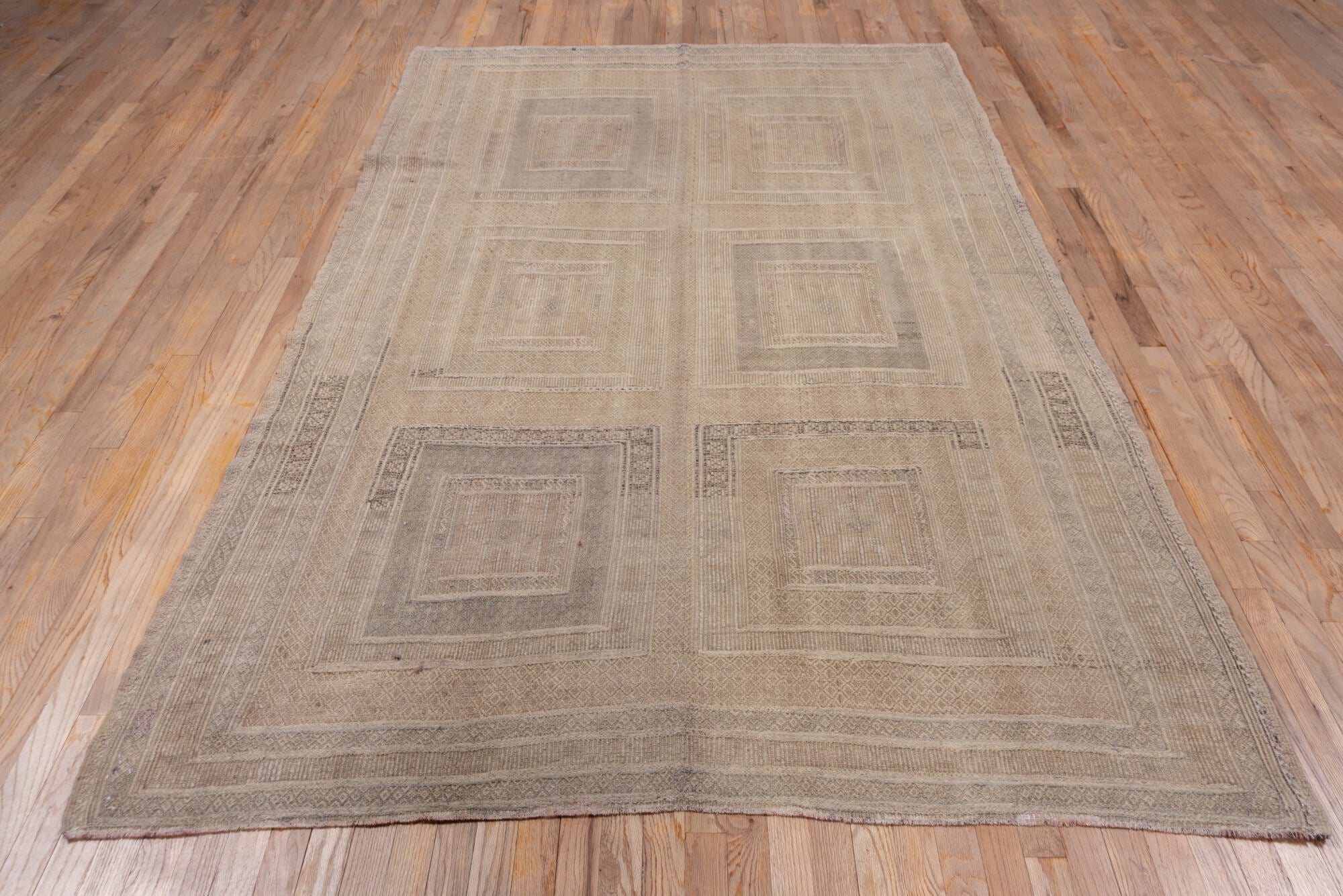5' x 9' one-of-a-kind handmade vintage Jijim medium size rug. Color palette: gray, light gray, off-white, pink, snow, white