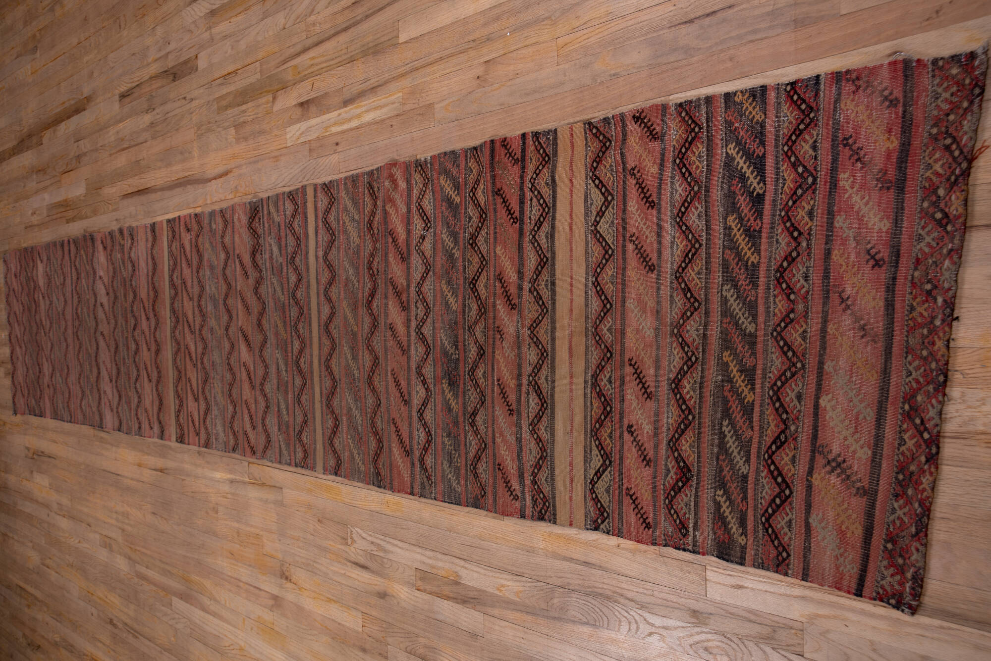 2' x 15' one-of-a-kind handmade vintage Jijim runner rug. Color palette: brown, gray, off-white, pink, red, redwood, snow