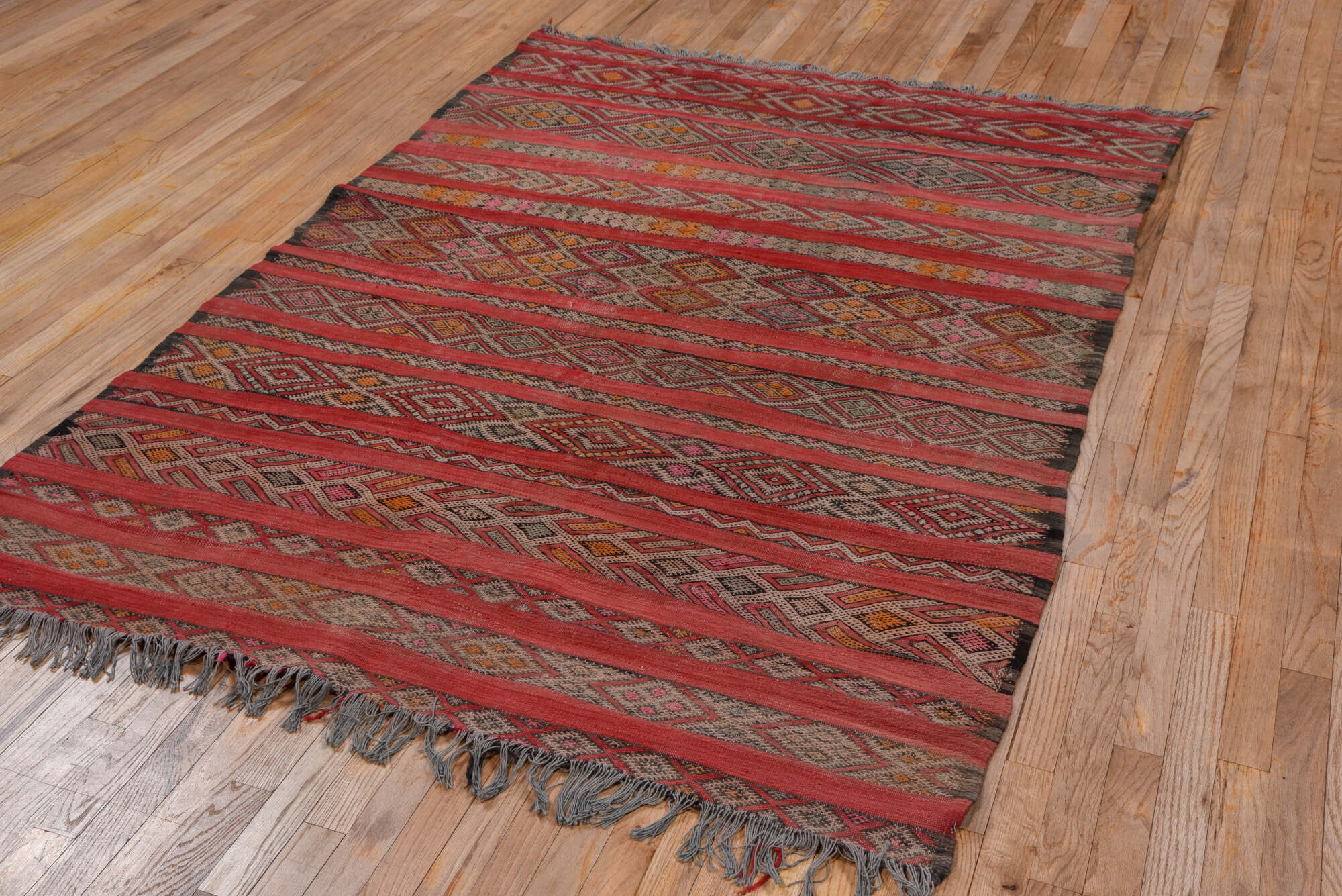 5' x 7' one-of-a-kind handmade vintage Kilim rug. Color palette: brown, gray, light gray, pink, red, redwood