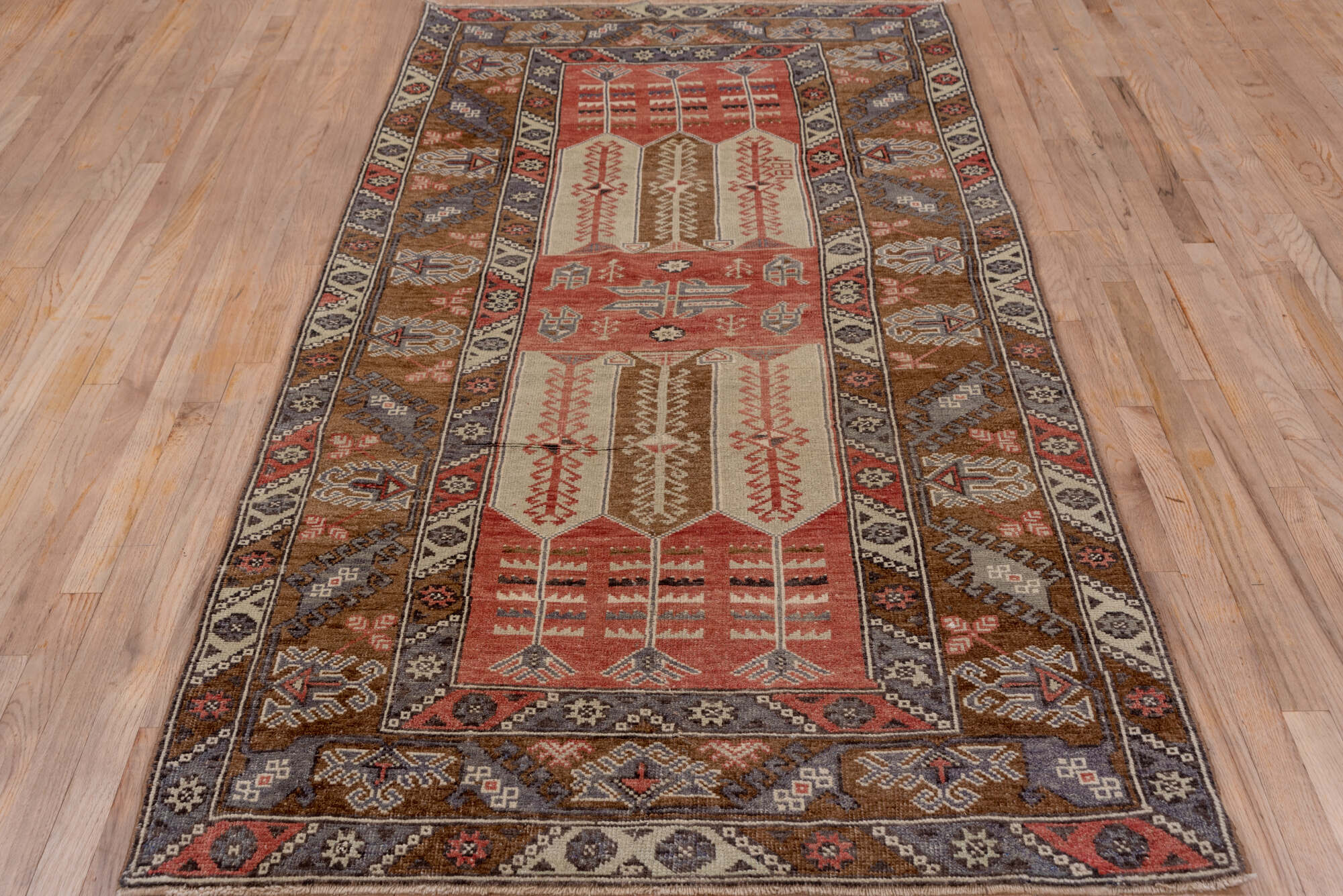 4' x 8' one-of-a-kind handmade vintage Konya runner rug. Color palette: brown, gray, pink, red