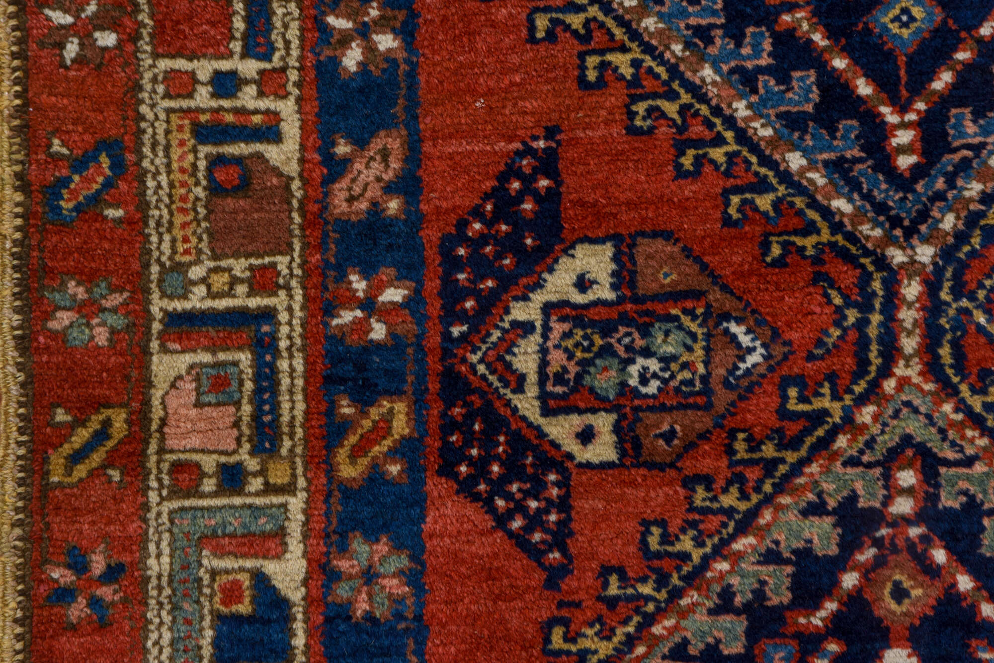 3' x 9' one-of-a-kind handmade vintage Heriz runner rug. Color palette: blue, brown, gray, maroon, pink, red, redwood