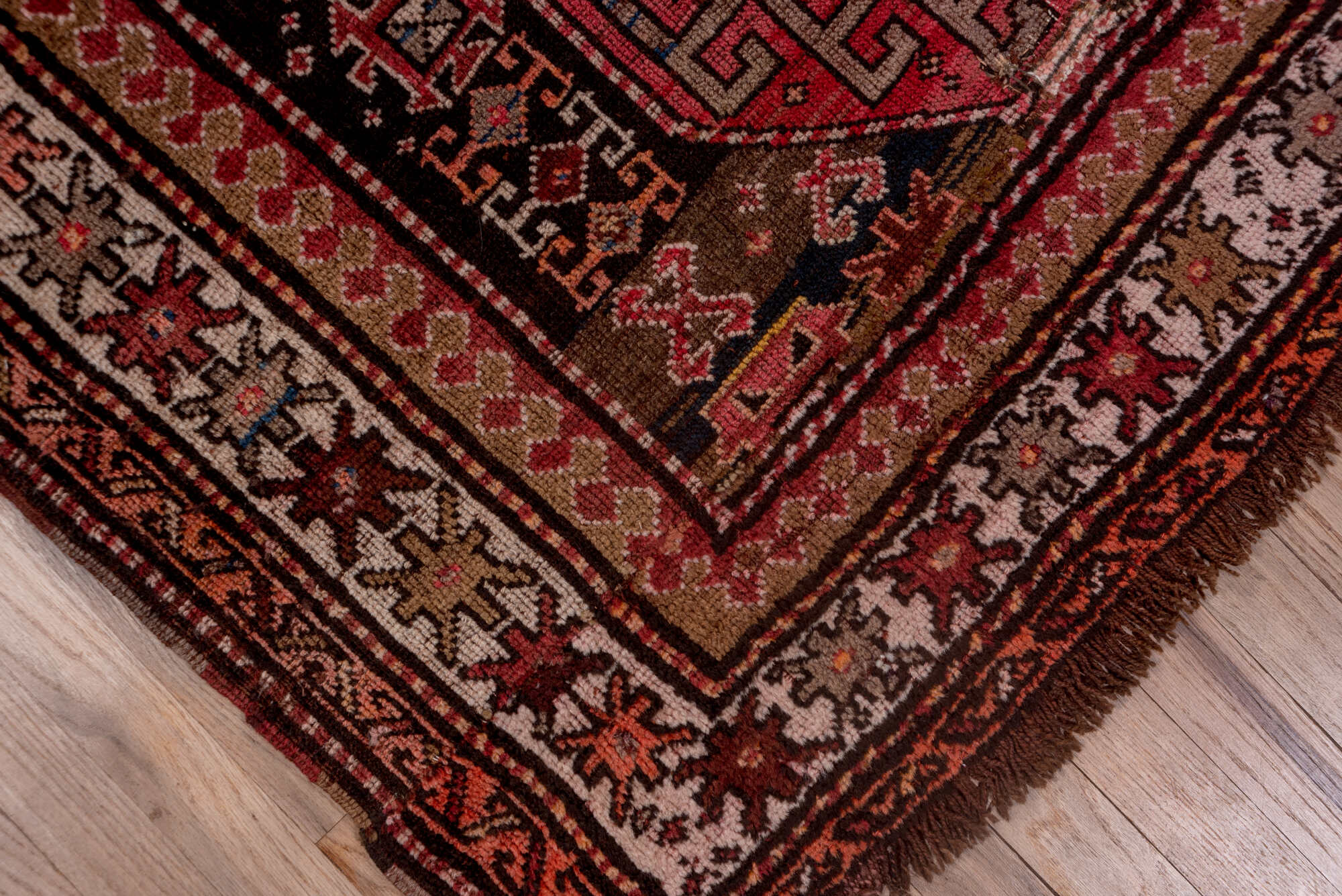 4' x 9' one-of-a-kind handmade vintage Kazak runner rug. Color palette: brown, gray, pink, red, rosy brown