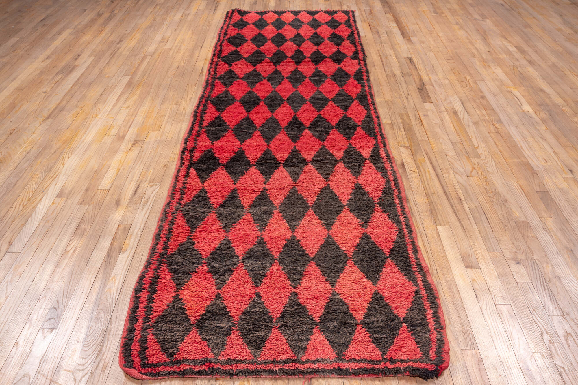 3' x 11' one-of-a-kind handmade vintage Moroccan runner rug. Color palette: black, brown, gray, indian red, pink, red