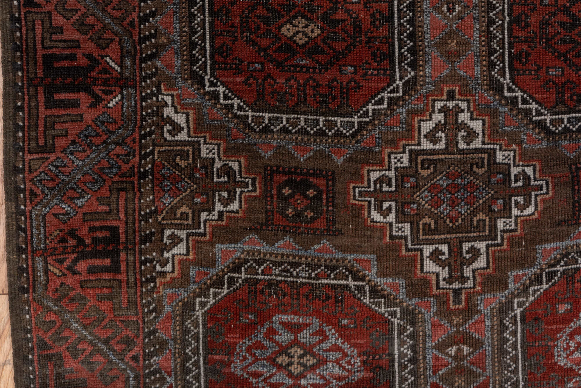 3' x 6' one-of-a-kind handmade vintage Belouch small size rug. Color palette: brown, gray, pink, red, redwood