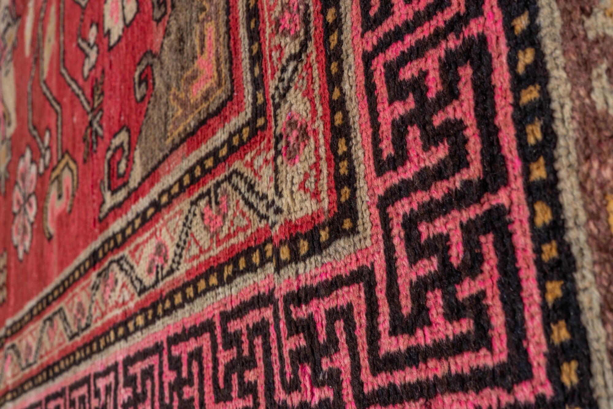 4' x 8' one-of-a-kind handmade vintage Khotan rug. Color palette: black, brown, pink, red