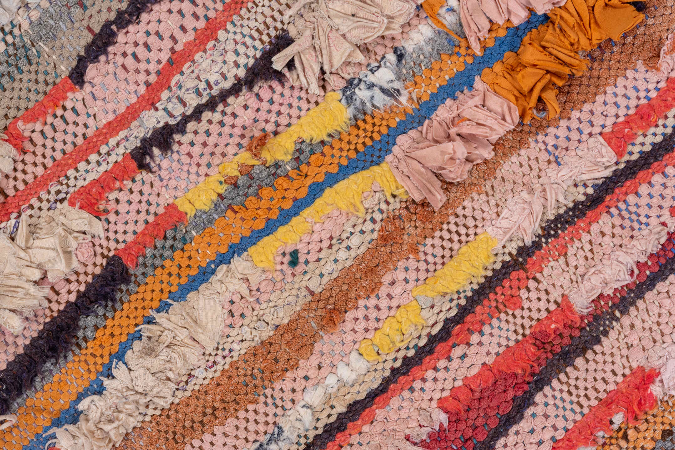 4' x 7' one-of-a-kind handmade vintage Rag Rug rug. Color palette: red, brown, gray, blue, pink, light gray, off-white
