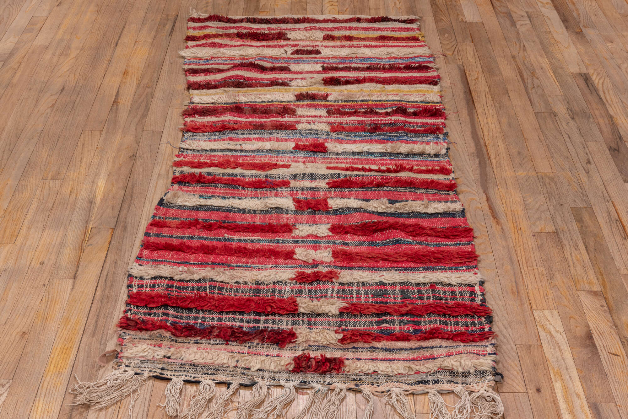 2' x 6' one-of-a-kind handmade vintage Rag Rug runner rug. Color palette: black, blue, brown, gray, light gray, off-white