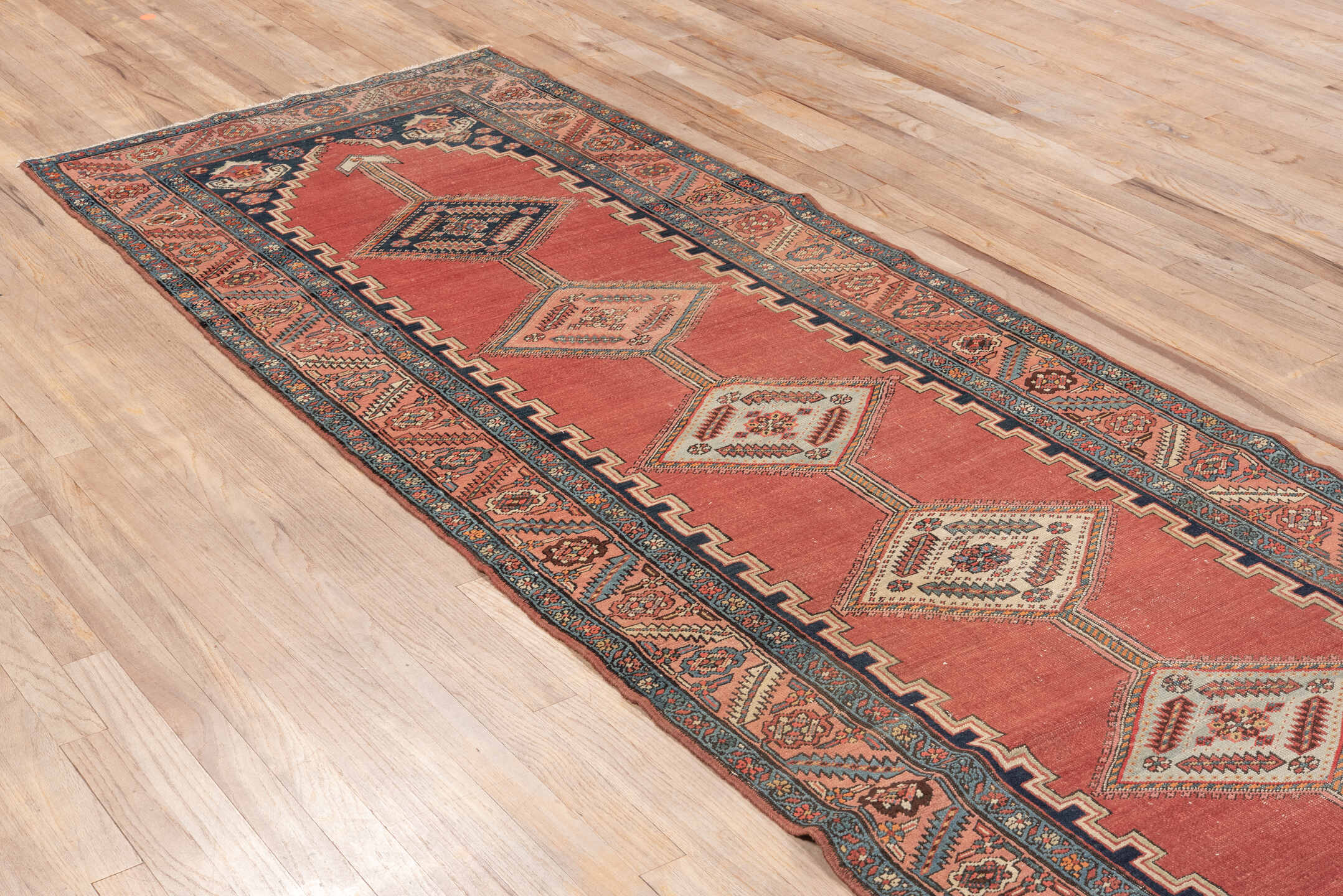 3' x 12' one-of-a-kind handmade vintage Serapi runner rug. Color palette: gray, pink, red, off-white, light gray, black